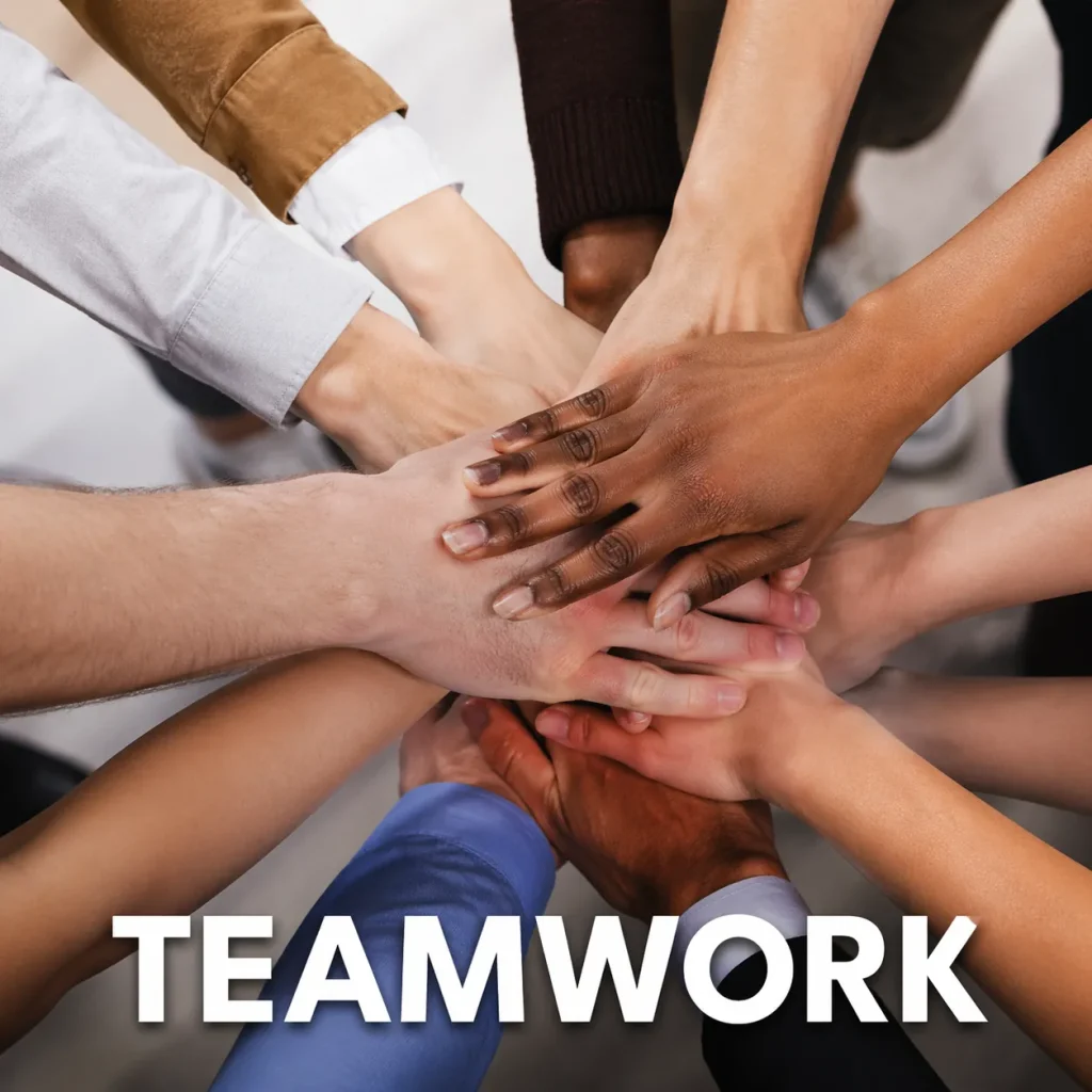 Hands from diverse people stack together in a circle to symbolize teamwork and unity.