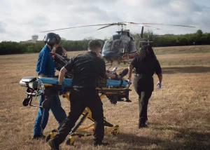 an image of EMT professionals in Houston Taking a person onto the emergency helicopter.